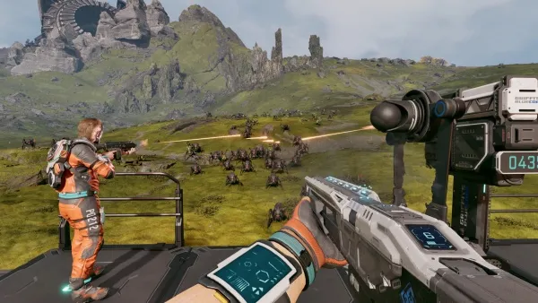 A first-person perspective of a futuristic soldier in an orange and gray suit, holding a high-tech weapon with a holographic display. The soldier is on a grassy hillside overlooking a battlefield with multiple enemy soldiers advancing towards them. In the background, there are large, rocky formations and a massive structure resembling a fortress or observatory. The sky is clear with some clouds.