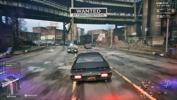 A high-speed chase scene in a video game, featuring a black sports car with red brake lights racing down an urban street. The player's vehicle is pursued by police cars, and there is a "WANTED" sign displayed on the bridge overhead. The environment includes industrial buildings, a train track, and various vehicles on the road. The game interface shows health and armor status, weapon selection, and other gameplay elements. The atmosphere is intense and action-packed.
