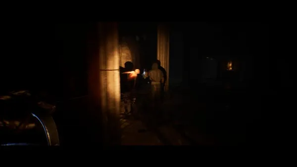 A dimly lit alleyway at night, with a few people standing near a doorway. The scene is shrouded in shadows and the only source of light appears to be coming from within the building or streetlights in the distance. There are some objects on the ground that could be debris or personal belongings. The atmosphere is tense and mysterious.
