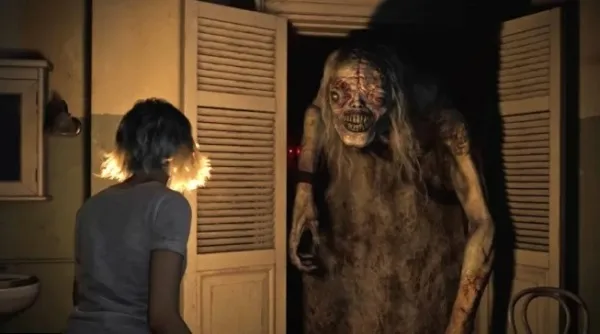 A woman in a dimly lit room, facing a monstrous figure with long hair and a skeletal appearance, standing behind an open door. The scene is eerie and suspenseful, with shadows cast on the walls and a sense of impending danger.